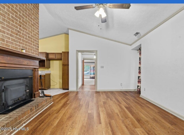5200 Pineview Rd, Lumberton, NC 28360 - unfurnished living room with vaulted ceiling, light wood finished floors, ceiling fan, baseboards, and a fireplace