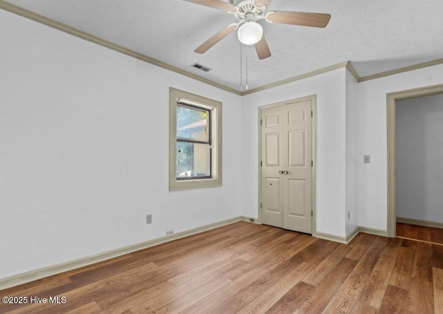 5200 Pineview Rd, Lumberton, NC 28360 - unfurnished bedroom with ornamental molding, light wood finished floors, baseboards, ceiling fan, and a textured ceiling