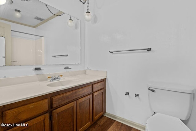 5200 Pineview Rd, Lumberton, NC 28360 - full bath with wood finished floors, toilet, vanity, ornamental molding, and baseboards