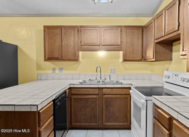 5200 Pineview Rd, Lumberton, NC 28360 - kitchen featuring white range with electric stovetop, a sink, black dishwasher, a peninsula, and tile counters