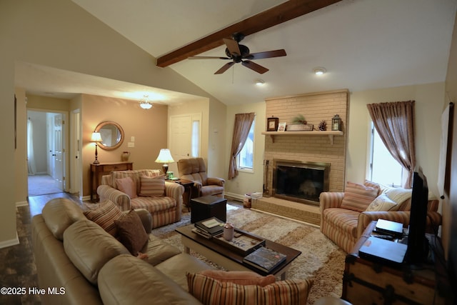 living room featuring lofted ceiling with beams, a fireplace, baseboards, and a wealth of natural light