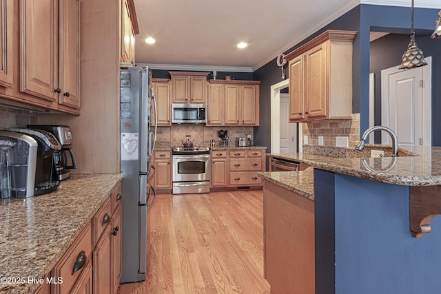 kitchen featuring stainless steel appliances, light stone countertops, light wood-style floors, and ornamental molding