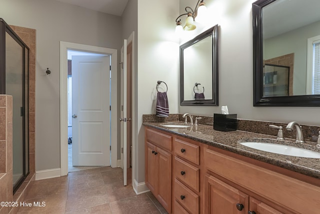 full bath featuring double vanity, tile patterned flooring, a sink, and a shower stall