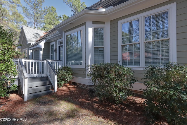 view of property exterior with roof with shingles