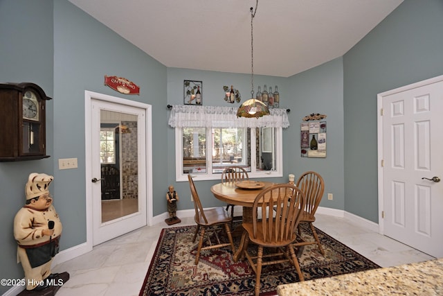 dining space featuring marble finish floor and baseboards