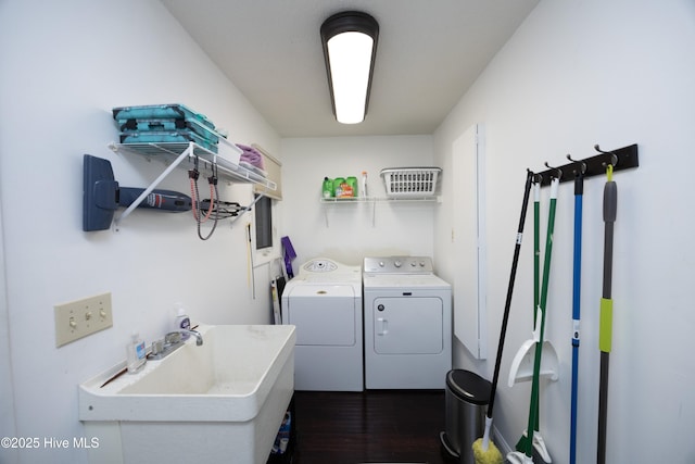 laundry room featuring dark wood-style floors, laundry area, a sink, and washer and dryer