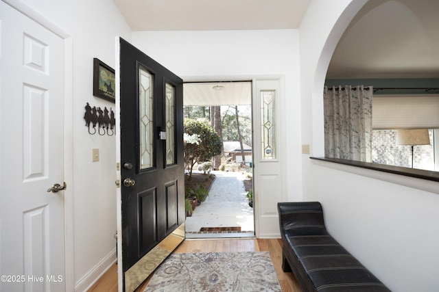 foyer with baseboards and wood finished floors