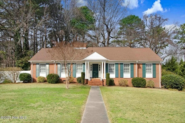 view of front of house with crawl space, brick siding, and a front yard