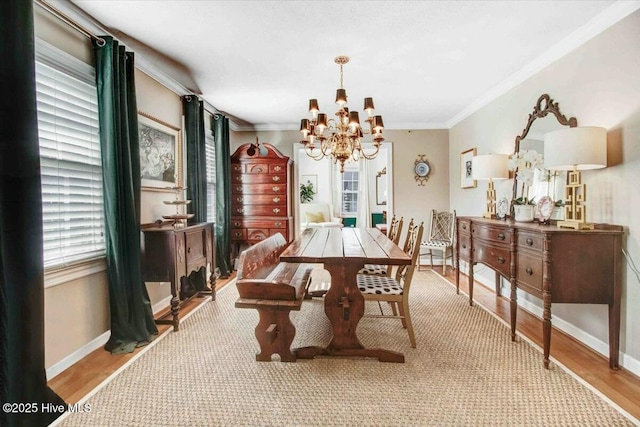 dining room with crown molding, a wealth of natural light, and a notable chandelier