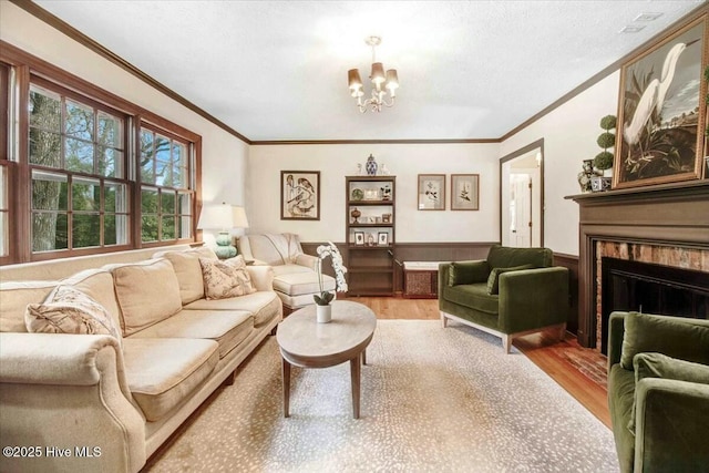 living room featuring ornamental molding, a fireplace, and wood finished floors