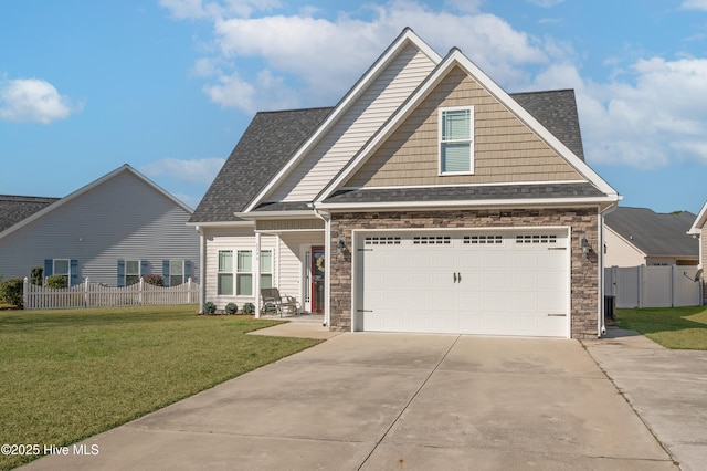 craftsman-style house featuring roof with shingles, concrete driveway, fence, a garage, and a front lawn