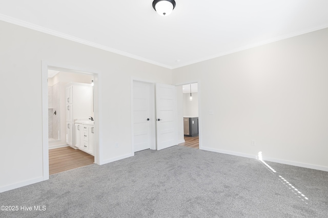 unfurnished bedroom featuring carpet flooring, crown molding, and baseboards