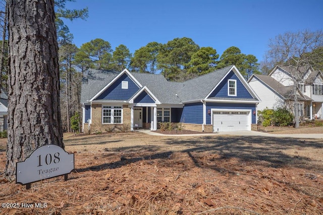 craftsman house with a garage and brick siding