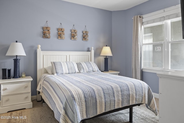 bedroom featuring multiple windows and baseboards