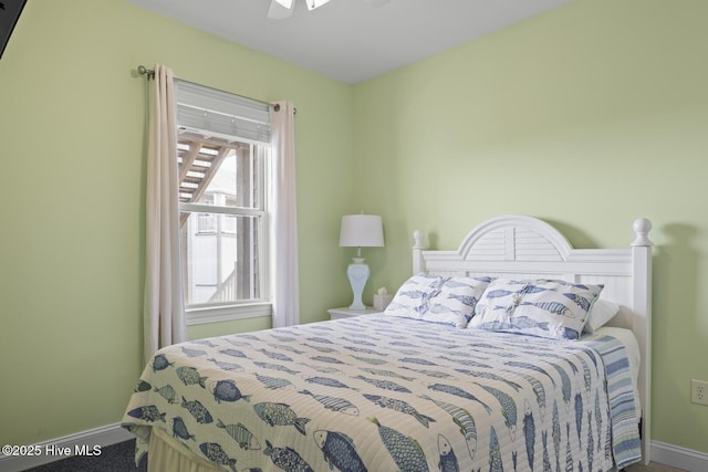 bedroom with ceiling fan and baseboards