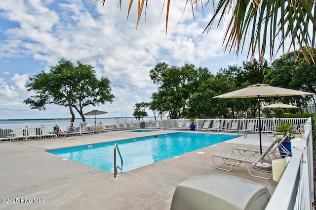 pool featuring a patio area and fence