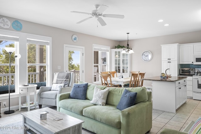 living area with recessed lighting, a toaster, ceiling fan, and light tile patterned flooring