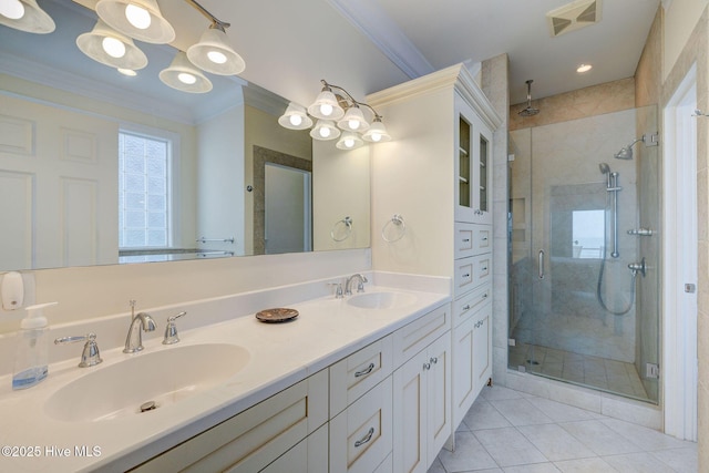 full bathroom with a shower stall, a sink, visible vents, and crown molding