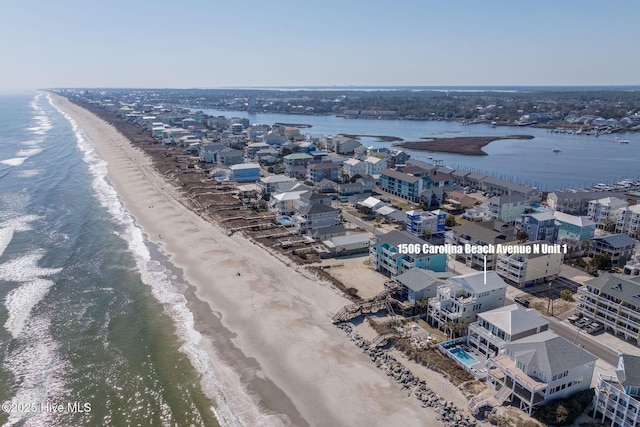 aerial view with a water view and a view of the beach