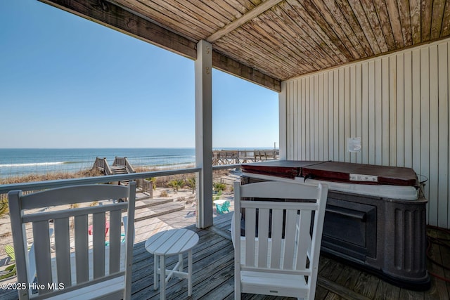 wooden terrace with a beach view and a water view