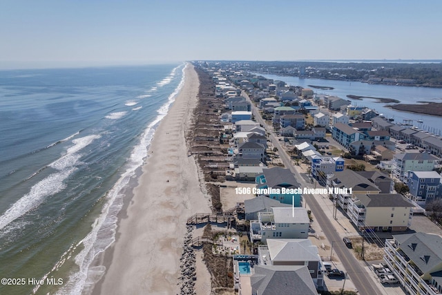 drone / aerial view with a water view and a beach view