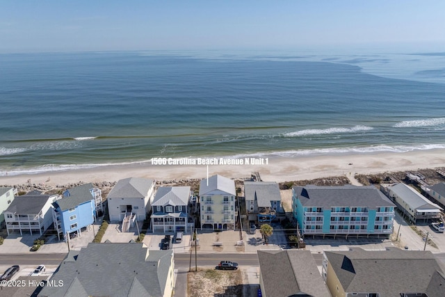 birds eye view of property with a water view, a residential view, and a view of the beach