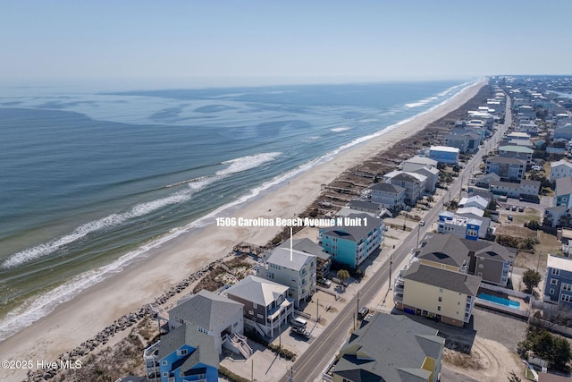 aerial view with a water view and a beach view