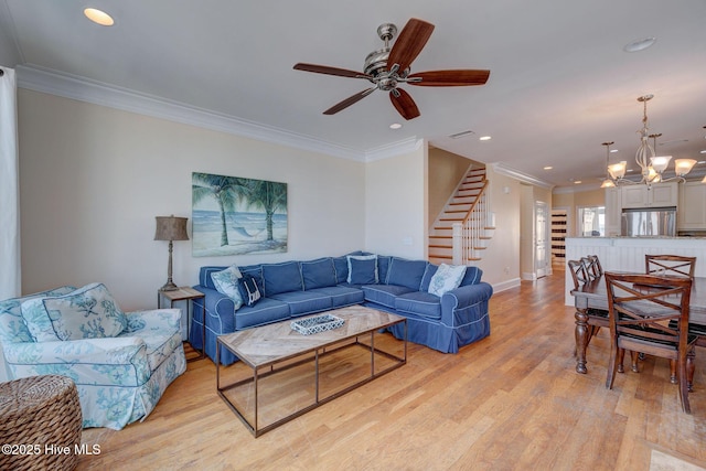 living area with light wood-style flooring, recessed lighting, baseboards, stairs, and ornamental molding