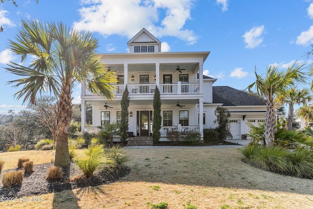 view of front of house with a garage, a ceiling fan, a balcony, covered porch, and a front lawn