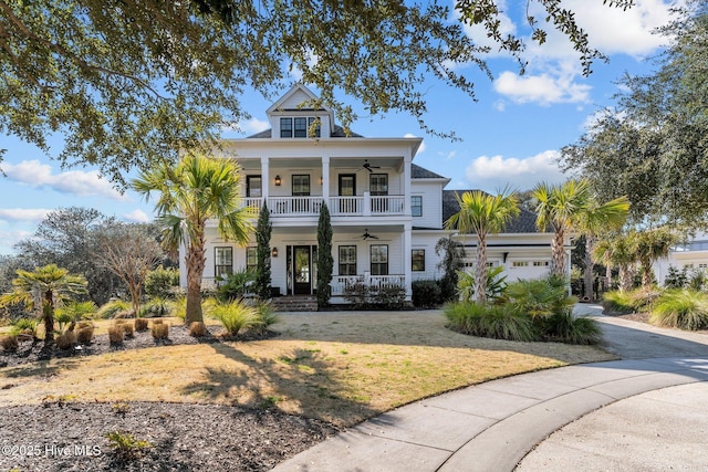 view of front facade with a porch, ceiling fan, a balcony, a garage, and a front lawn