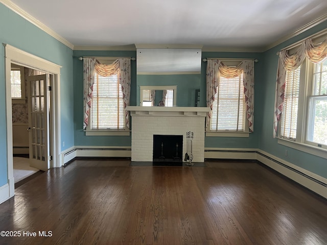 unfurnished living room with a brick fireplace, wood finished floors, a wealth of natural light, and crown molding