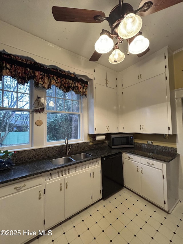 kitchen with black dishwasher, light floors, stainless steel microwave, white cabinets, and a sink