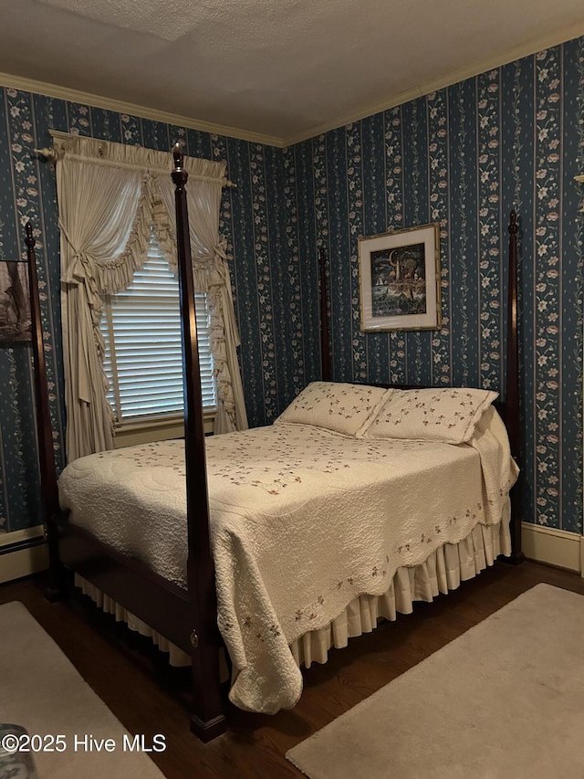 bedroom with a textured ceiling, ornamental molding, wood finished floors, and wallpapered walls