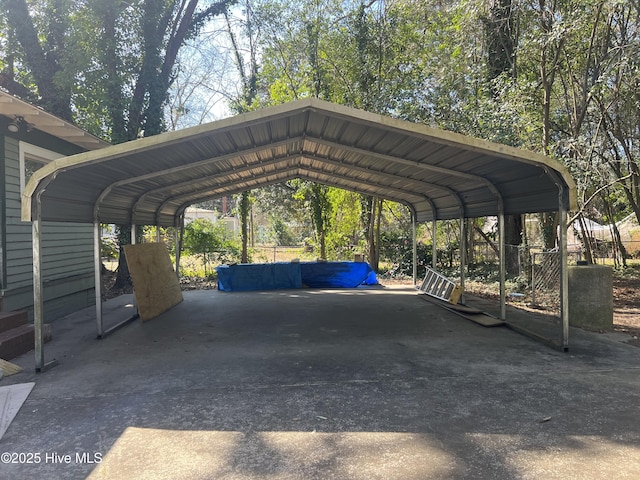 view of parking / parking lot with driveway and a detached carport