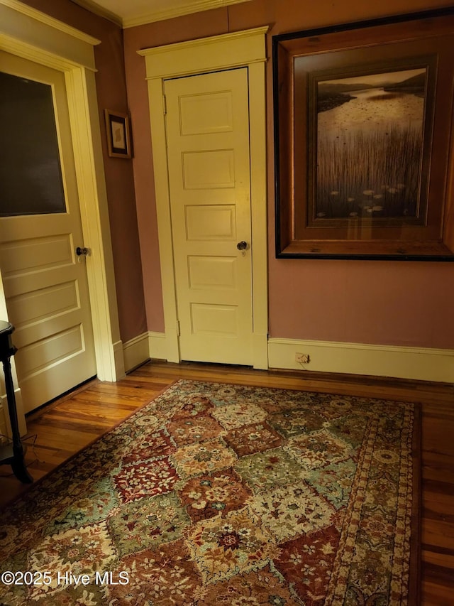 interior space featuring baseboards and wood finished floors