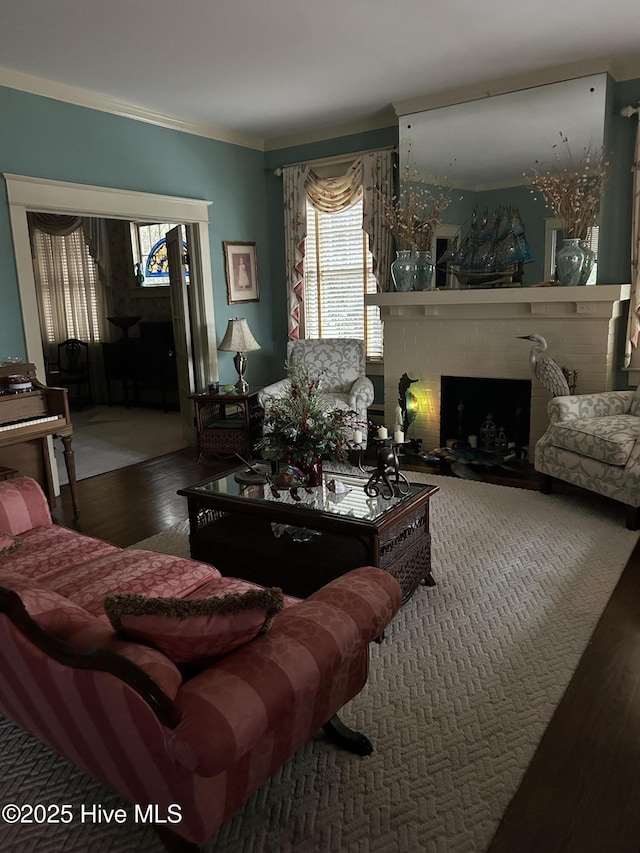 living area featuring a fireplace, crown molding, and wood finished floors