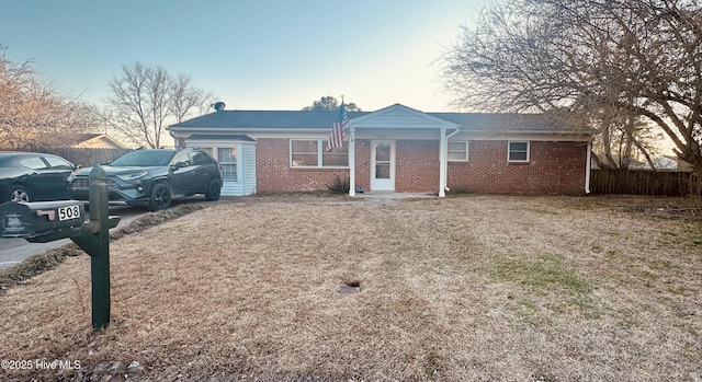 single story home featuring fence and brick siding