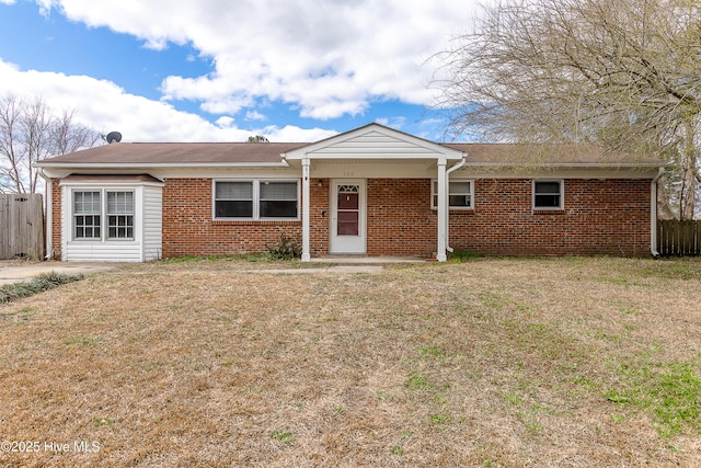 ranch-style house with brick siding, a front yard, and fence