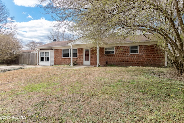 ranch-style house with brick siding and a front yard