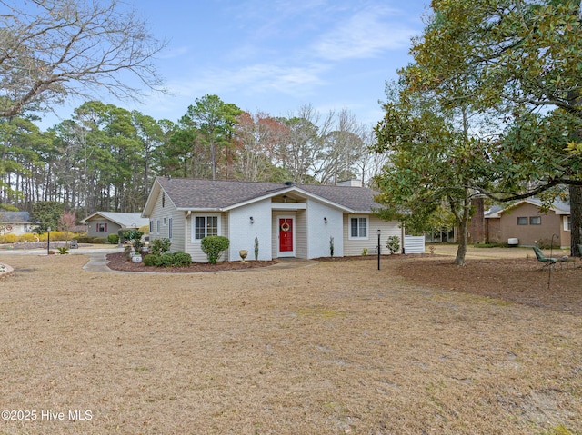 ranch-style home featuring a chimney and roof with shingles