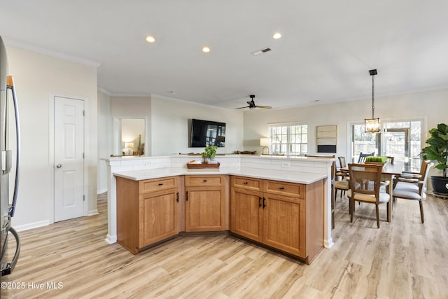 kitchen with light countertops, visible vents, and light wood-style flooring