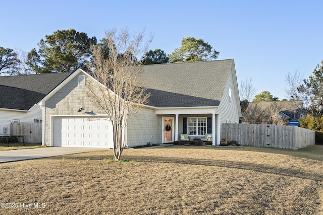 view of front of home featuring a shingled roof, fence, driveway, and an attached garage