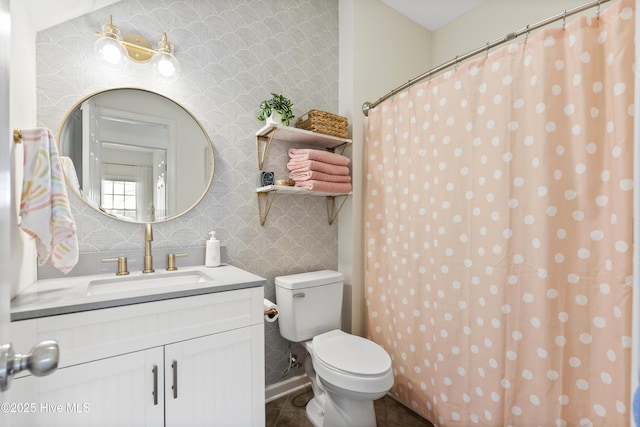 bathroom with tile patterned floors, vanity, toilet, and wallpapered walls