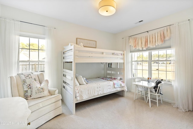 carpeted bedroom with visible vents and baseboards