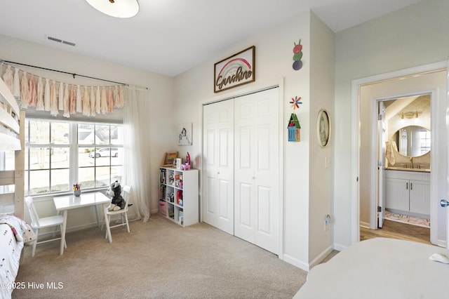 bedroom featuring a closet, baseboards, visible vents, and carpet flooring