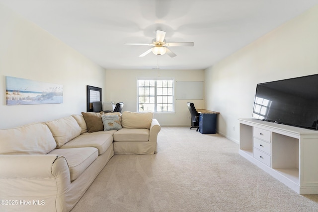 living room featuring carpet, baseboards, and a ceiling fan