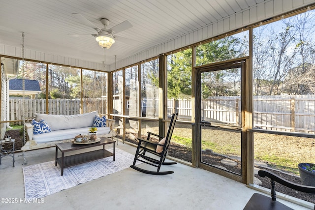 sunroom featuring a ceiling fan