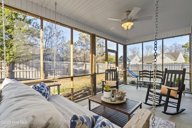 sunroom / solarium featuring ceiling fan