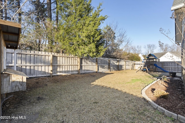 view of yard featuring a playground and a fenced backyard