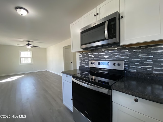 kitchen featuring a ceiling fan, white cabinets, appliances with stainless steel finishes, decorative backsplash, and dark wood finished floors